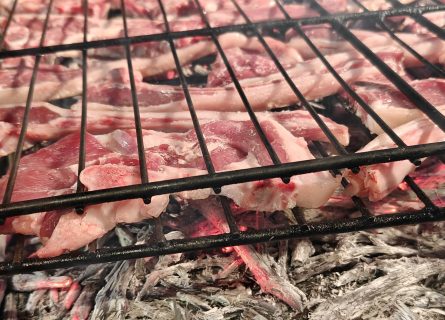 Chuletas de cordero (lamb chops) cooked on a grill over old vine branches